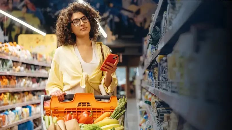 Woman redeeming a grocery gift card.