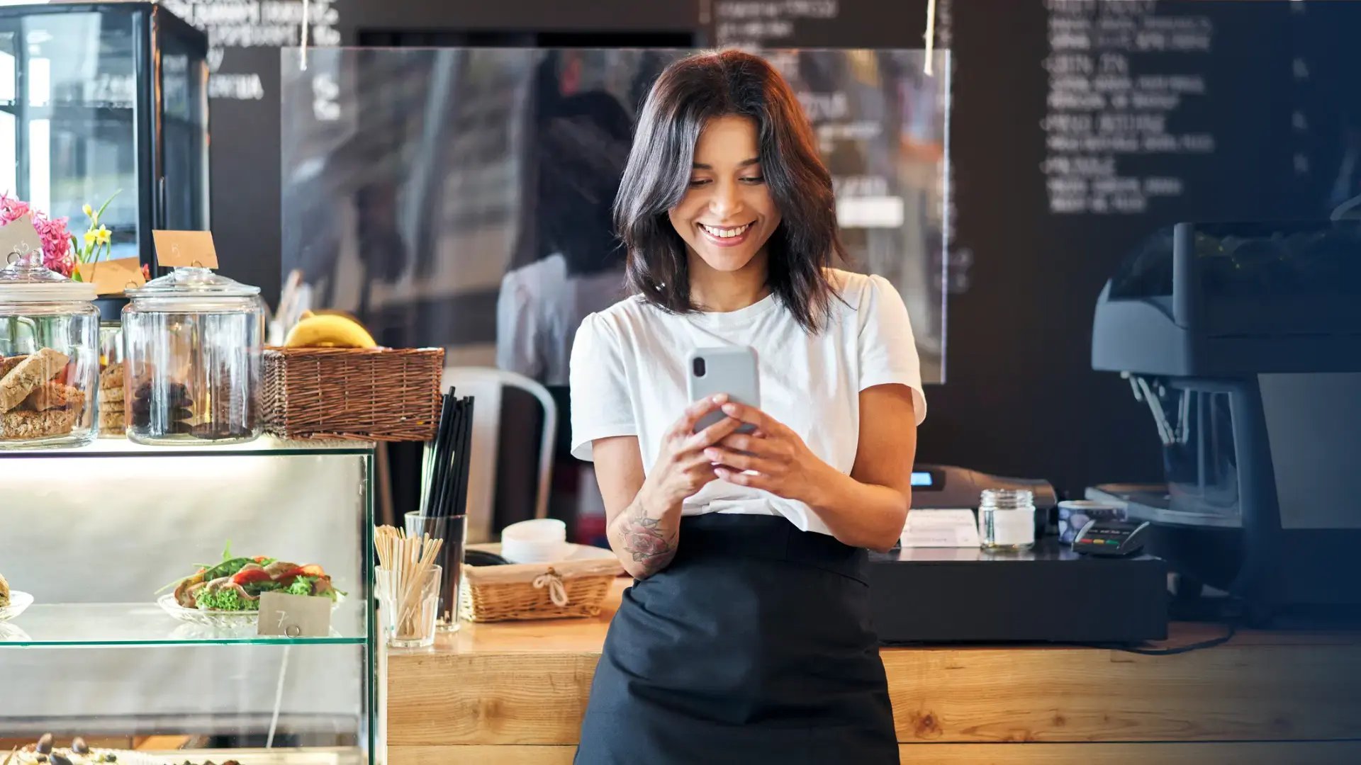 happy restaurant employee receiving a digital gift on her phone