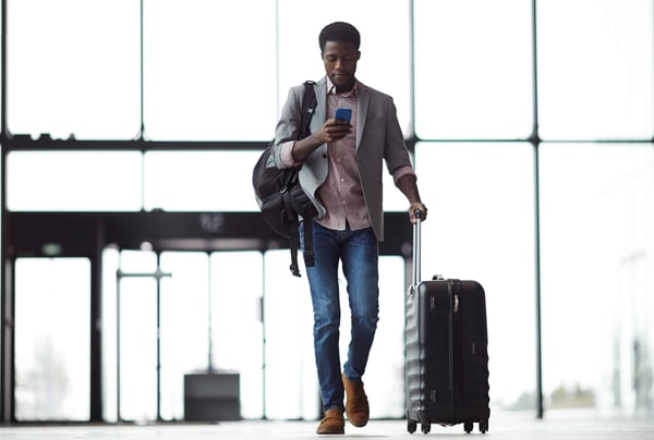OPT Blog Image - Employee walking in an airport to catch a business trip