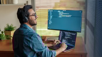 male coder at home office working on a prepaid card api integration