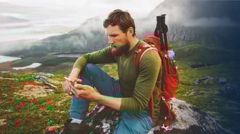male hiker in norway looking at phone 