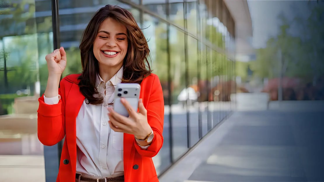 spiff incentive ideas featured image smiling businesswoman celebrating success looking at phone