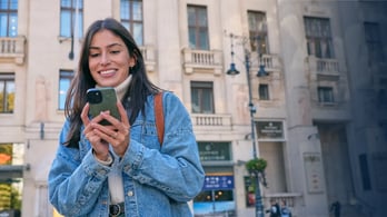 woman happy to be receiving an instant digital gift card on her cell phone
