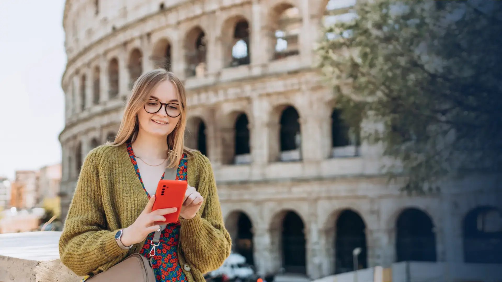 woman receiving a gift card on her phone near the colosseum 