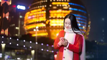 woman receiving a gift card on her phone while in Hangzhou, Zhejiang Province, China
